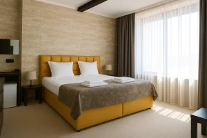 Double room with a yellow upholstered headboard